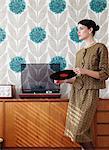 Woman in vintage dress with vinyl record