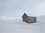 House in snow-covered field