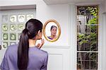 Woman examining her makeup in mirror