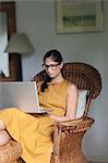 Woman using laptop in living room