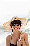 Woman holding pole on beach