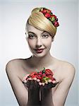 Woman holding handful of fruit