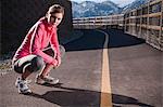 Runner stretching on rural road