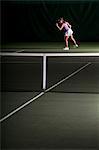 Woman playing tennis indoors