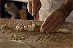 Close up of chef cutting gnocchi dough