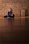 Woman practicing yoga on mat