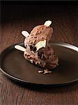 Dipped ice cream bars on wooden plate