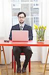 Businessman working on laptop at desk