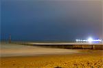 Waves rolling in on beach at night