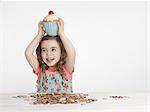 Girl holding cupcake jar on head