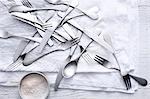 Silverware and flour on table