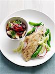 Plate of fish with beans and fruit salad