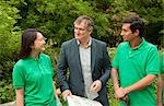 Gardeners with businessman in park