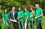 Gardeners with businessman in park