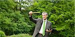 Businessman measuring distance in park