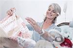 Older woman gathering fabric for sewing