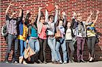 People posing together on city street