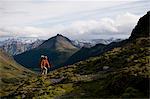 Hiker walking in grassy hills