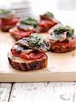 Toast with tomatoes, meat and herbs