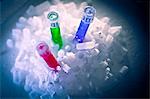 Test tubes of liquid in pile of ice