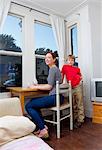 Mother and son sitting at desk