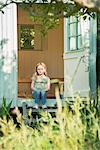 Girl sitting on steps in doorway