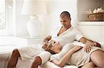 Couple relaxing on sofa in living room