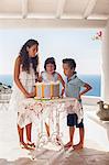 Children blowing out birthday candles