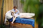 Couple relaxing on sofa outdoors