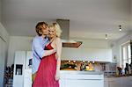 Couple dancing together in kitchen