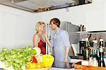 Couple talking in kitchen