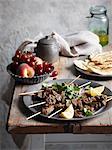 Plate of lamb skewers with lemon