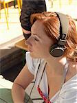 Woman in apron listening to headphones