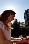 Woman in headphones having coffee