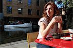 Woman drinking cup of coffee outdoors