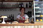 Woman in apron working at cafe