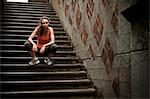 Woman resting on city steps