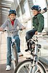 Children talking on bicycles in tunnel