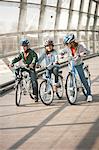 Children riding bicycles in city tunnel