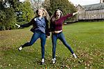 Smiling students playing on campus