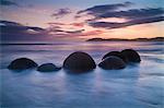 Waves washing over rocks on beach