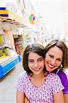 Mother and daughter smiling outdoors