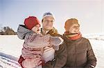 Smiling family walking in snow