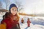 Woman walking with children in snow