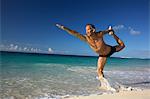 Man practicing yoga on tropical beach