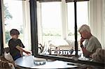 Man and grandson playing chess