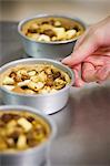 Baker with tins of nut cake