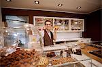 Cashier holding fruit cake in bakery