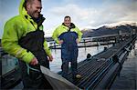 Workers on salmon farm in rural lake