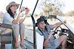Couple on safari in off road vehicle, Stellenbosch, South Africa